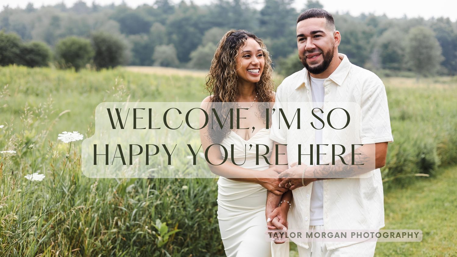 Couple embracing in a field with Welcome I'm So Happy You're Here text overlay by Taylor Morgan Photography.
