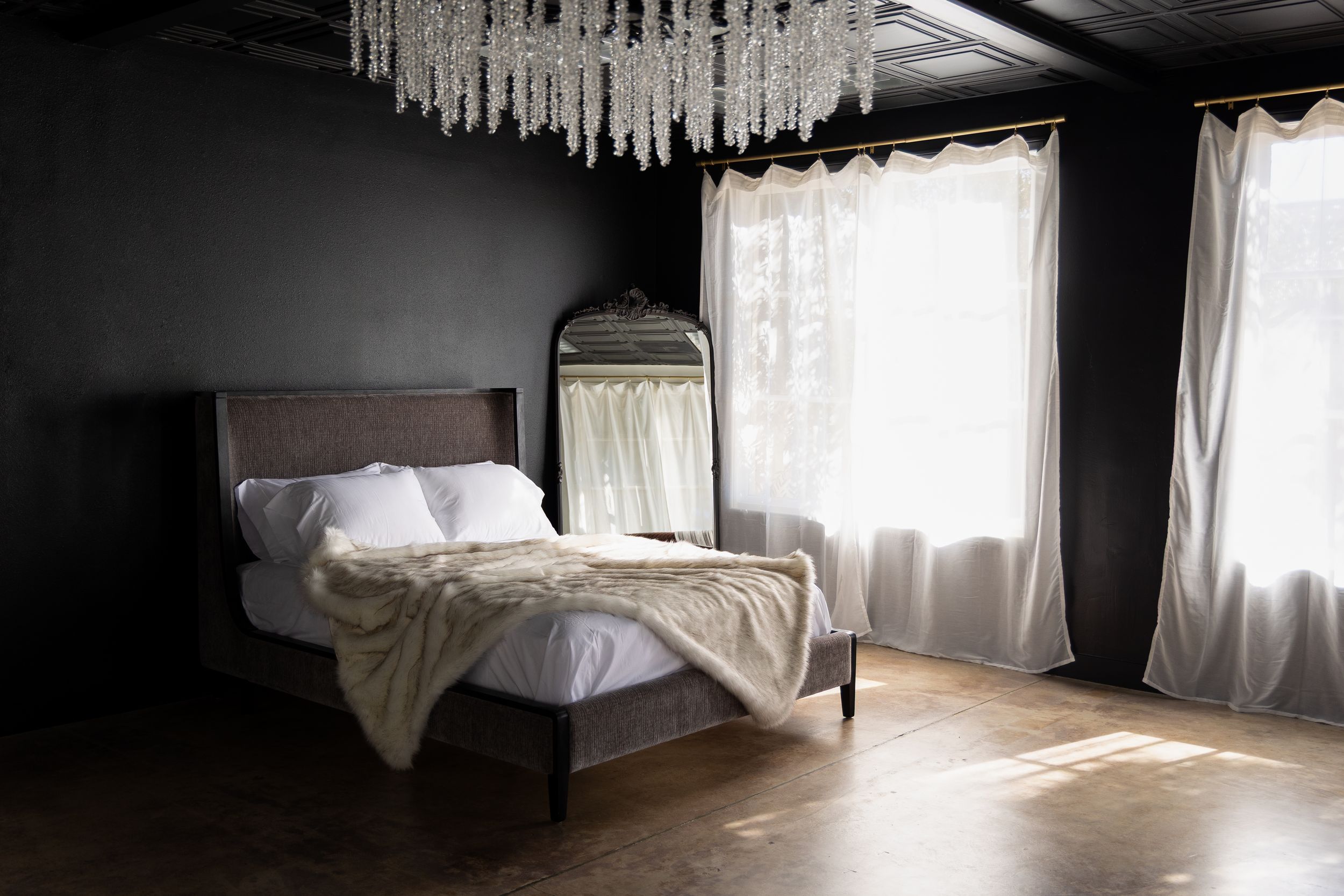 Luxury boudoir studio bedroom with a bed and soft white bedding