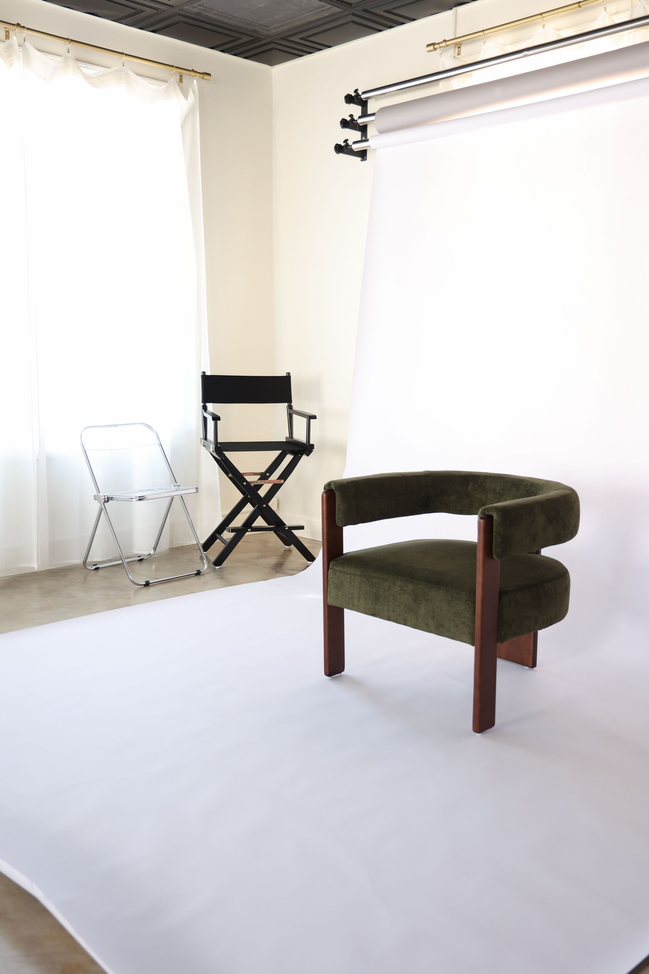 Natural light studio with paper backdrop and prop chair options