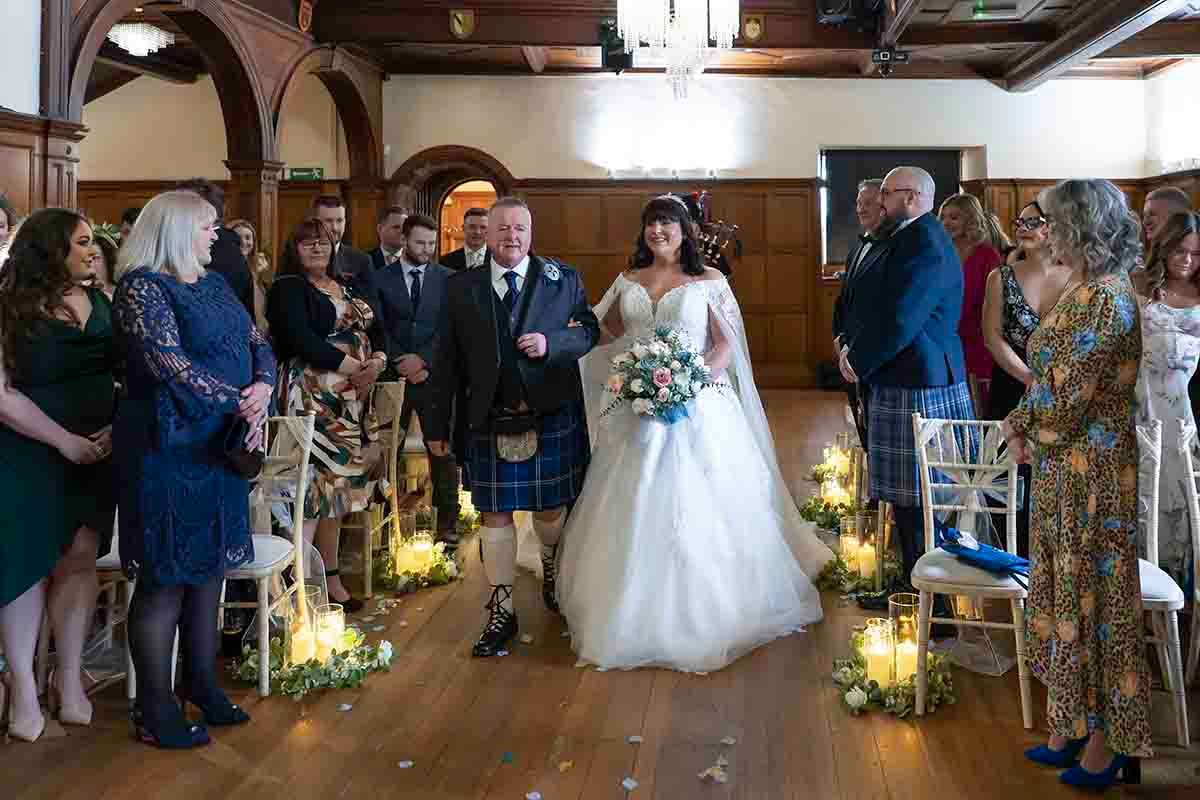 bride enters the baronial hall at Dalston Hall-Carlisle's premier wedding venue