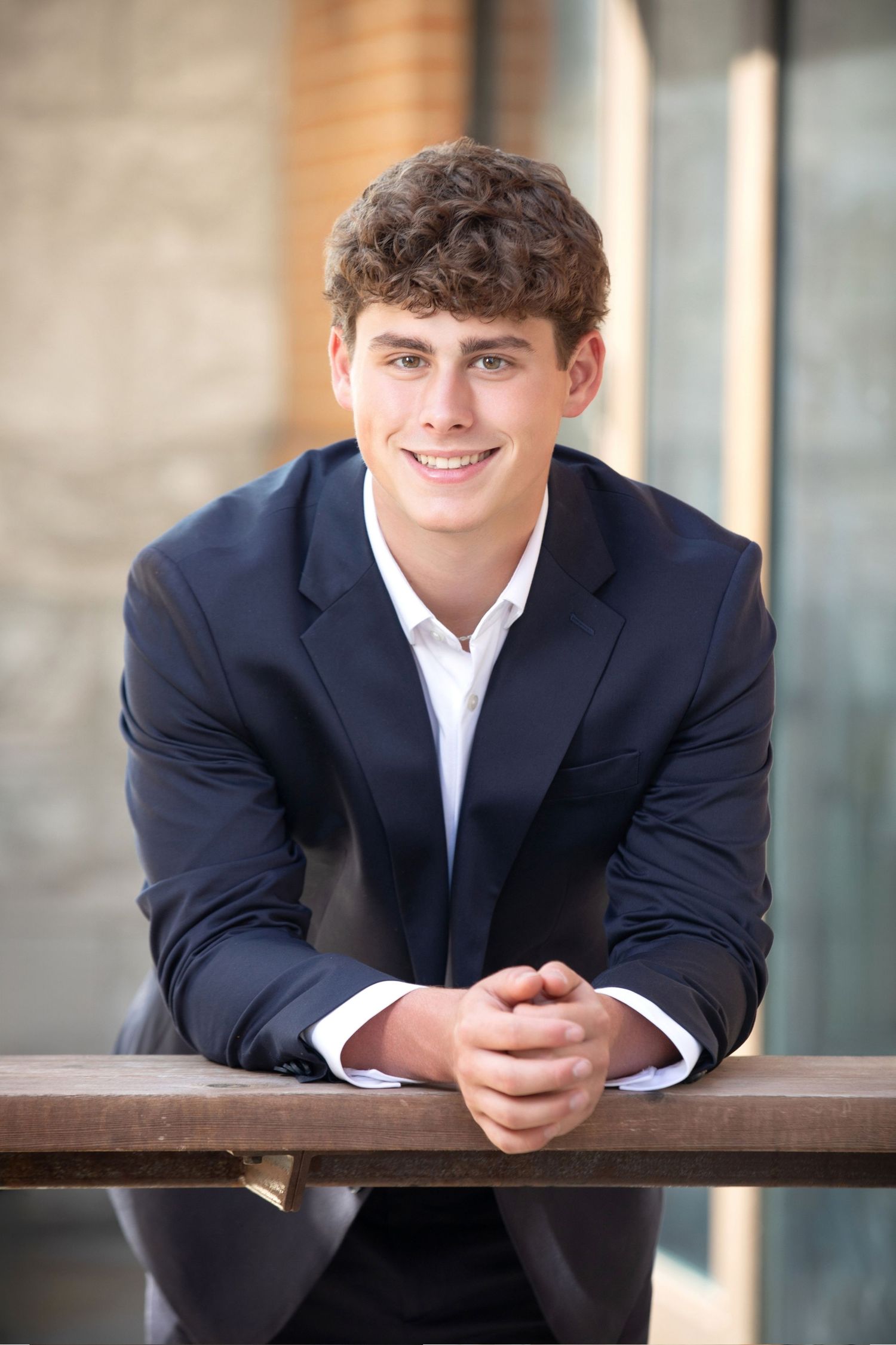 Olentangy senior guy portraits at Bridge Park with a polished suit look and modern downtown Dublin style.