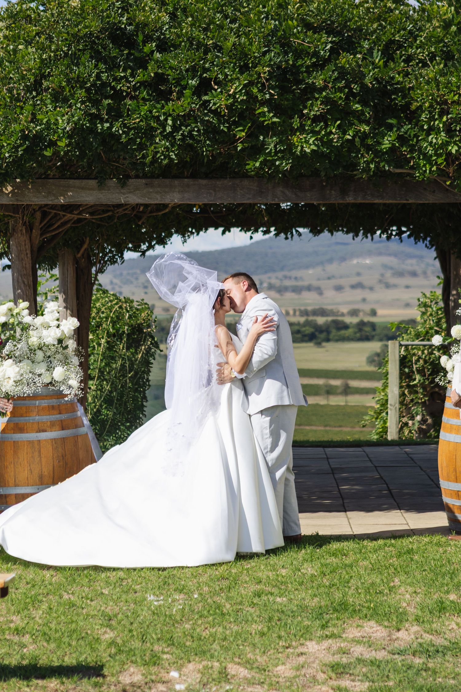 Bride and groom's first kiss at Two Rivers Winery Wedding in Denman