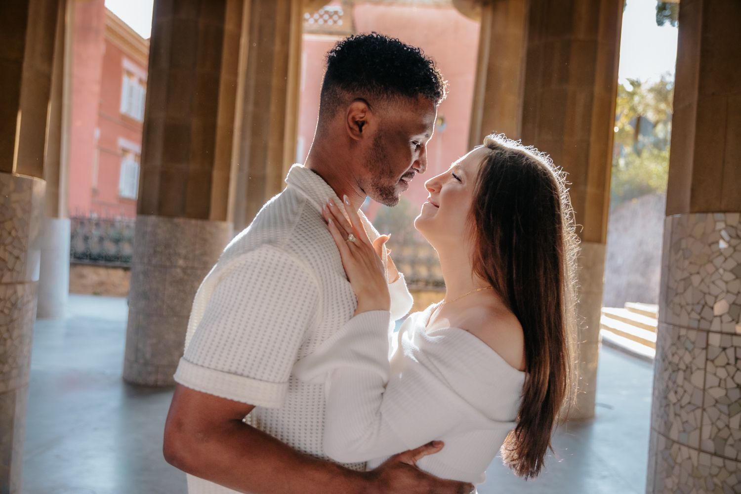 Alternative sunset couples photoshoot exploring the quiet hidden paths of Park Guell Barcelona under warm afternoon glow.