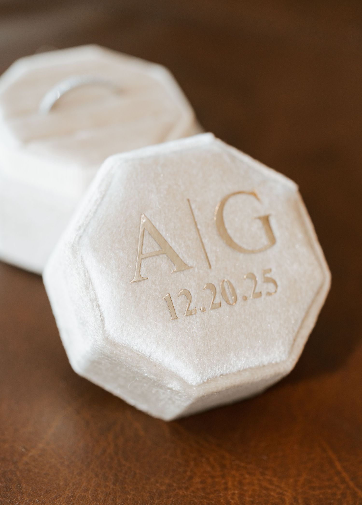 Ivory velvet octagonal ring box engraved with monogram A|G and wedding date 12.20.25.