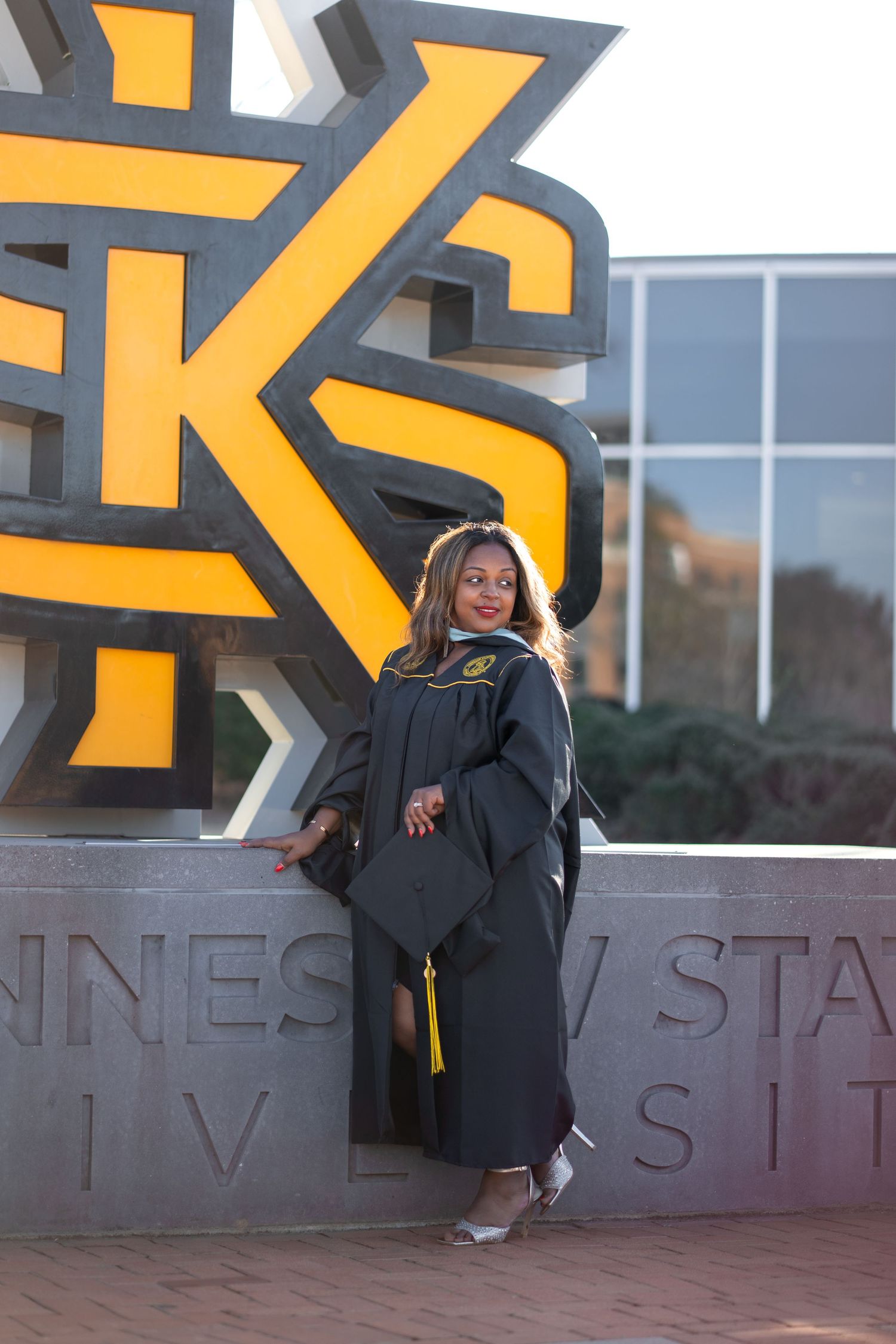 KSU graduation photos at the Kennesaw state sign on the Kennesaw college campus