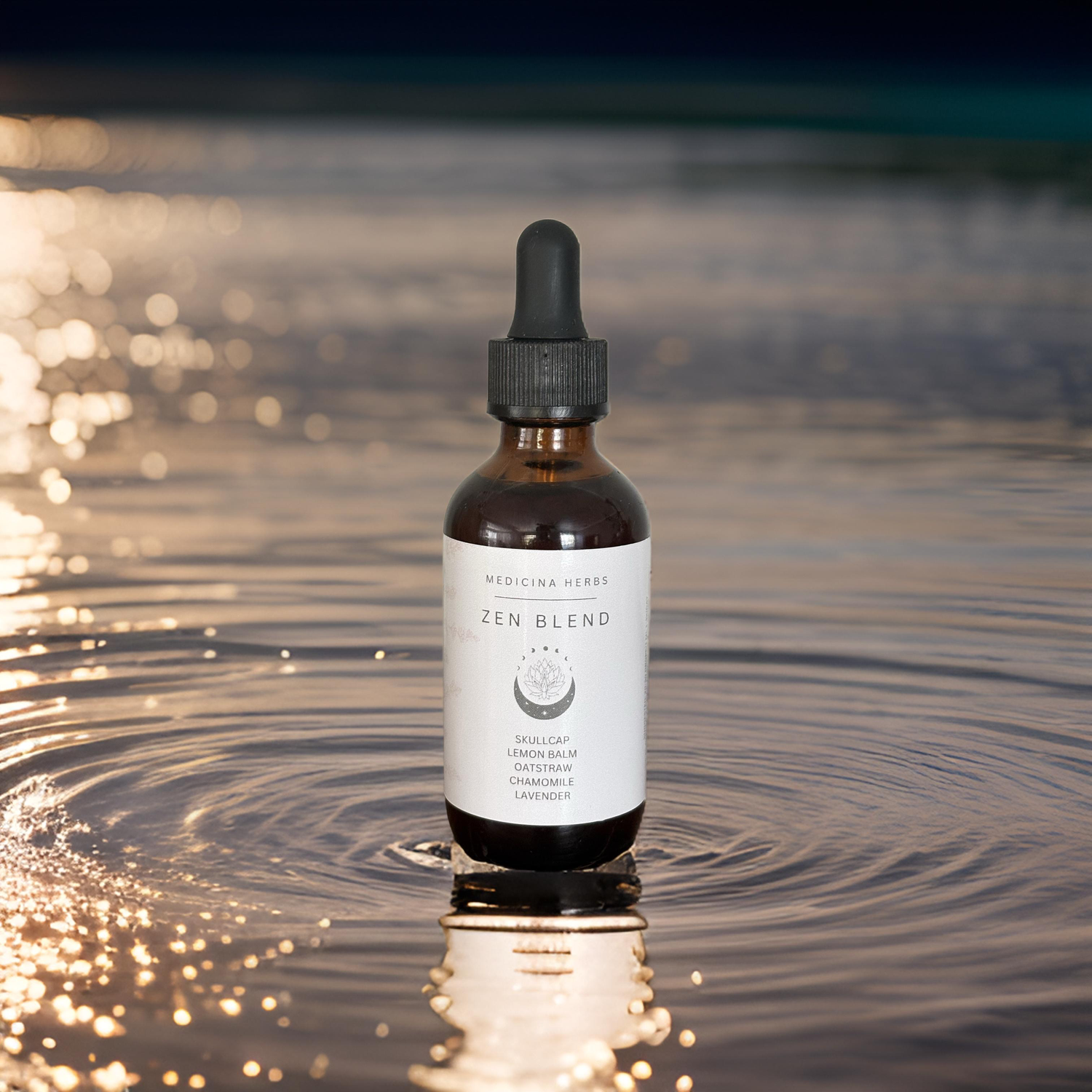 Brown dropper bottle of Jen Blend essential oil sitting on rippling water with golden sunset reflections.