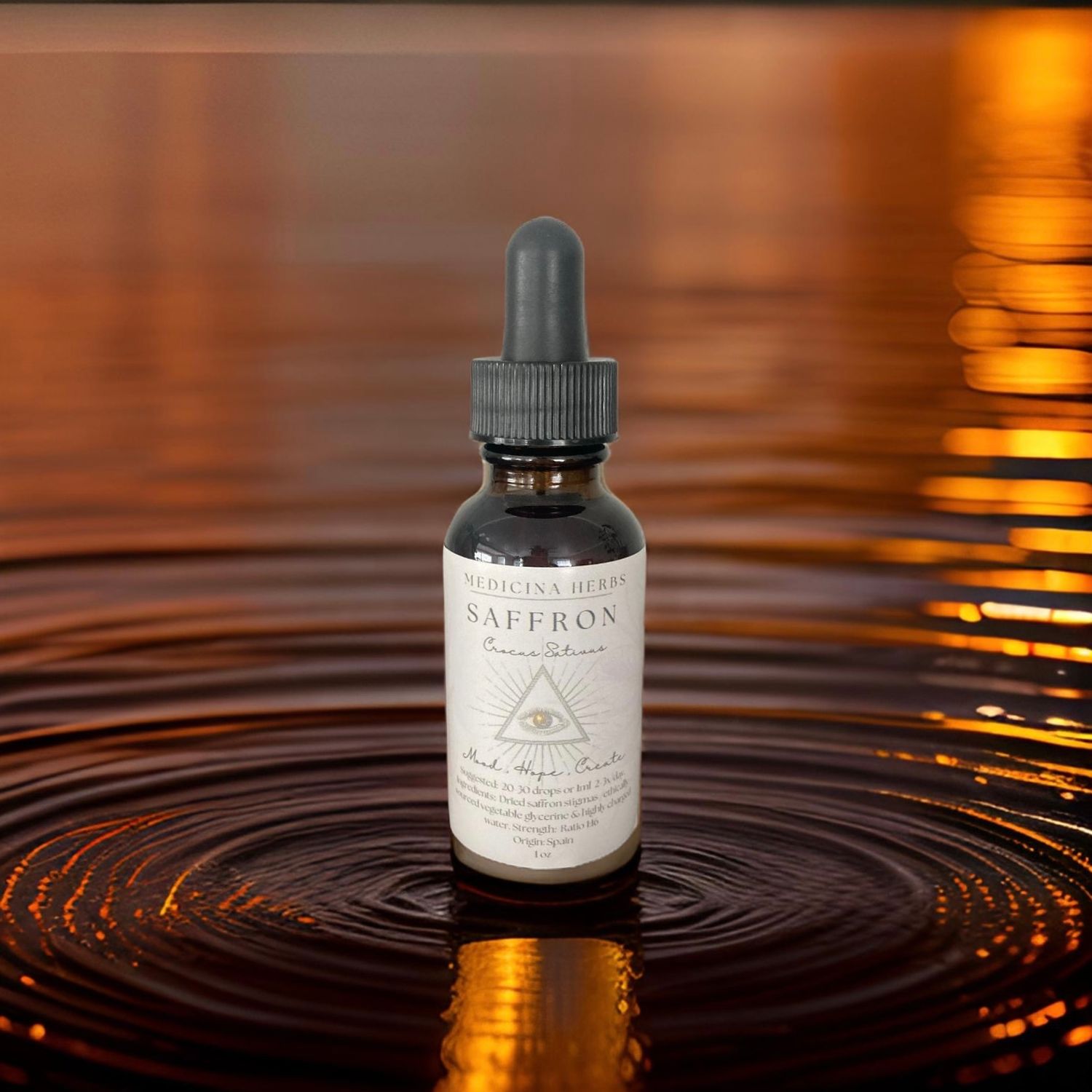 Saffron tincture dropper bottle sitting in rippling water with warm golden sunset reflection.