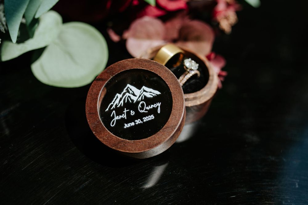 Custom engraved wooden ring box with mountain design for Jaci and Quincy's June 20, 2020 wedding.