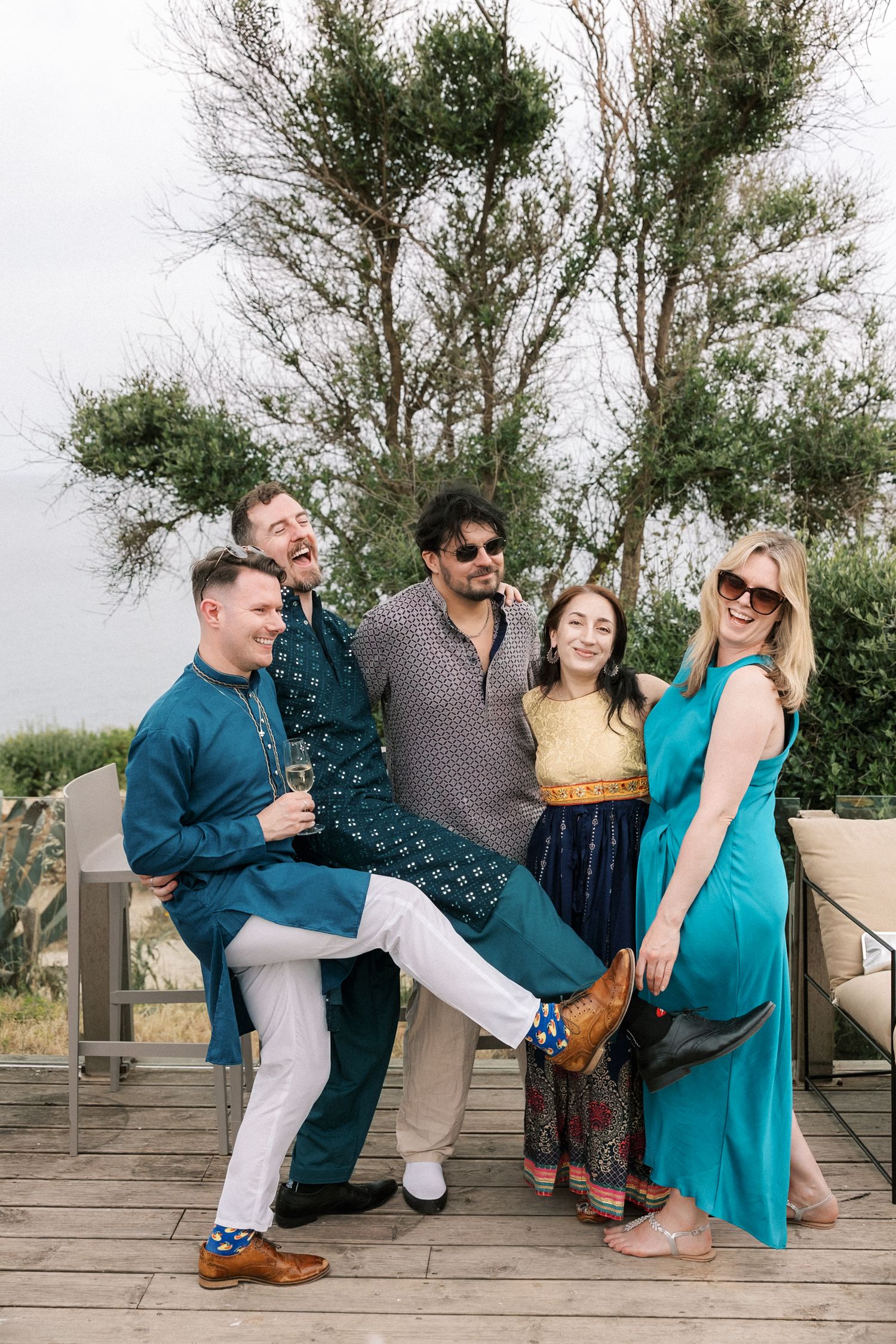 Wedding guests enjoying cocktails overlooking the Atlantic Ocean during a Mehndi and Sangeet celebration in Cascais.