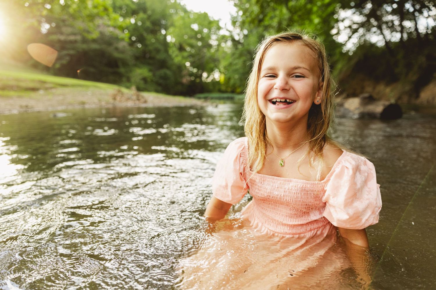 girl playing in creek during mini session