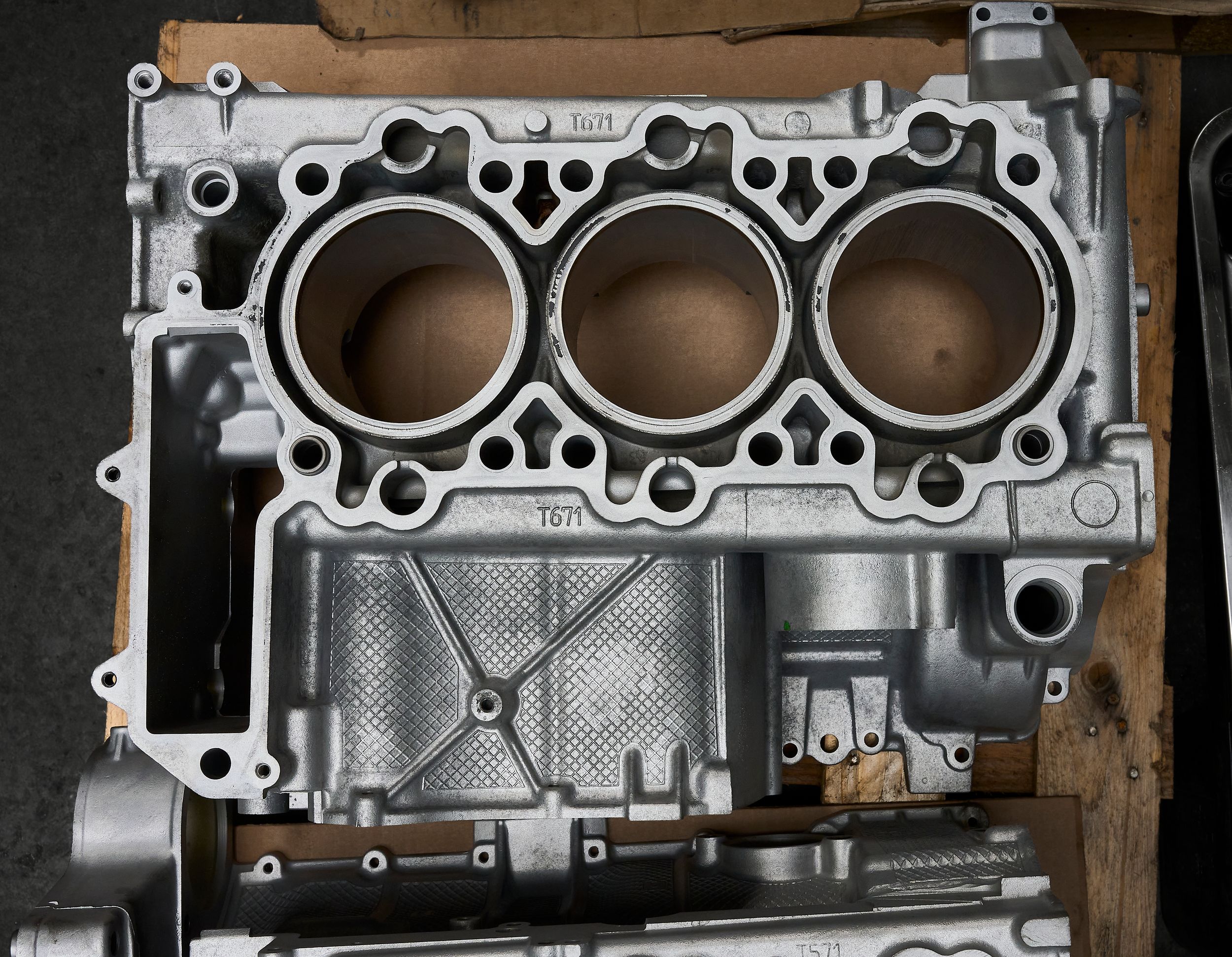 Bare aluminum V6 engine block with three cylinder bores visible, ready for rebuild or inspection.