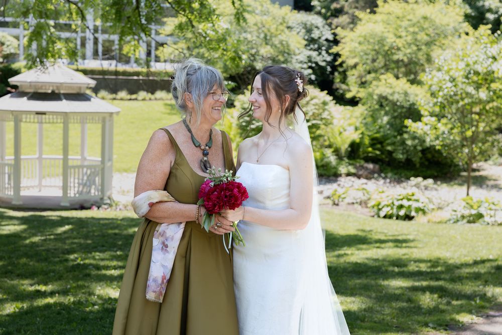 Bride and her mother share a moment surrounded by greenery at the civic garden complex in london, ontario.