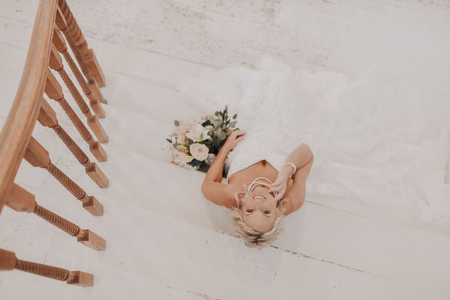Bride wearing an elegant sleeveless lace wedding gown at The White Sparrow