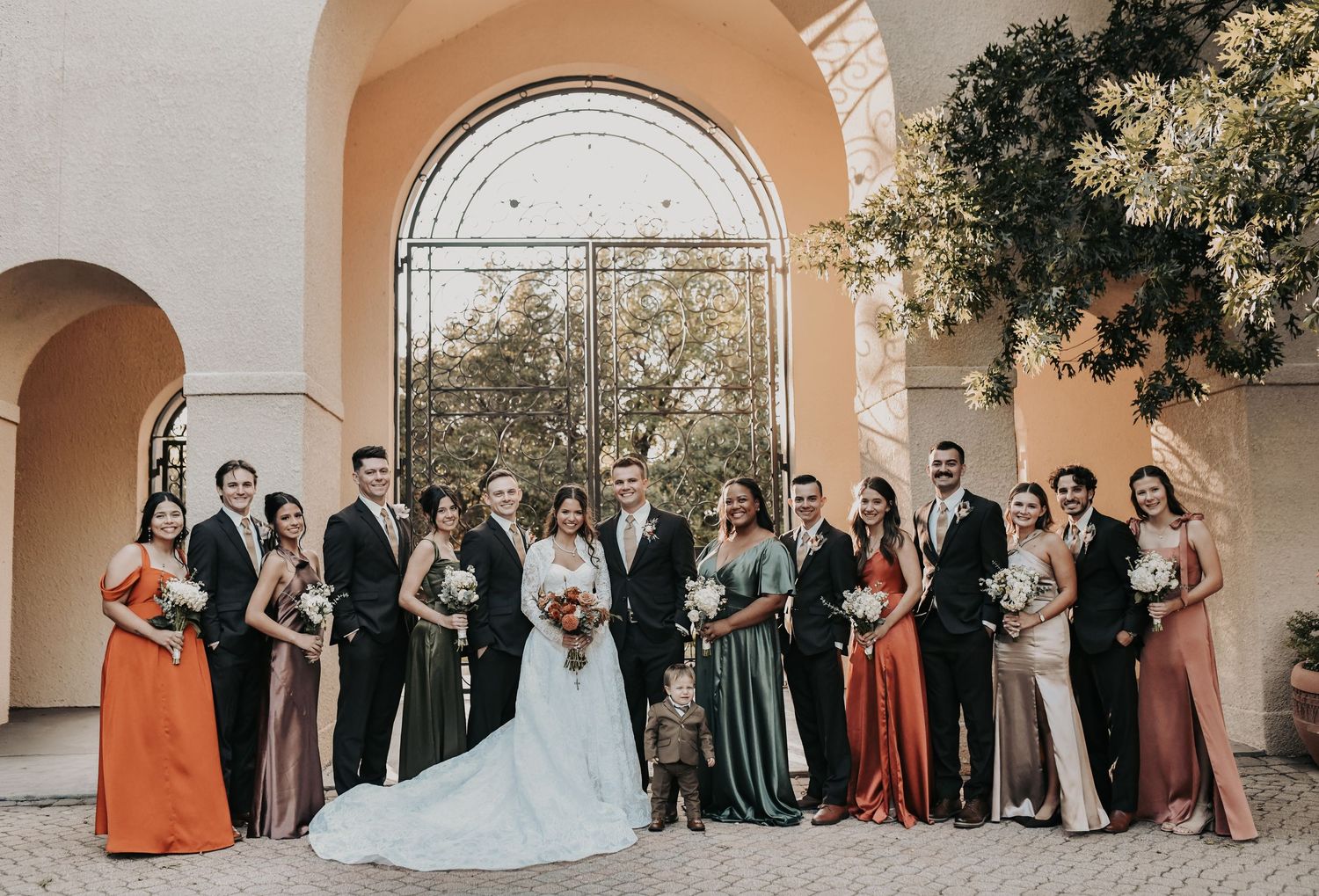 Newlyweds posing for wedding portraits in courtyard at St Ann Catholic Parish