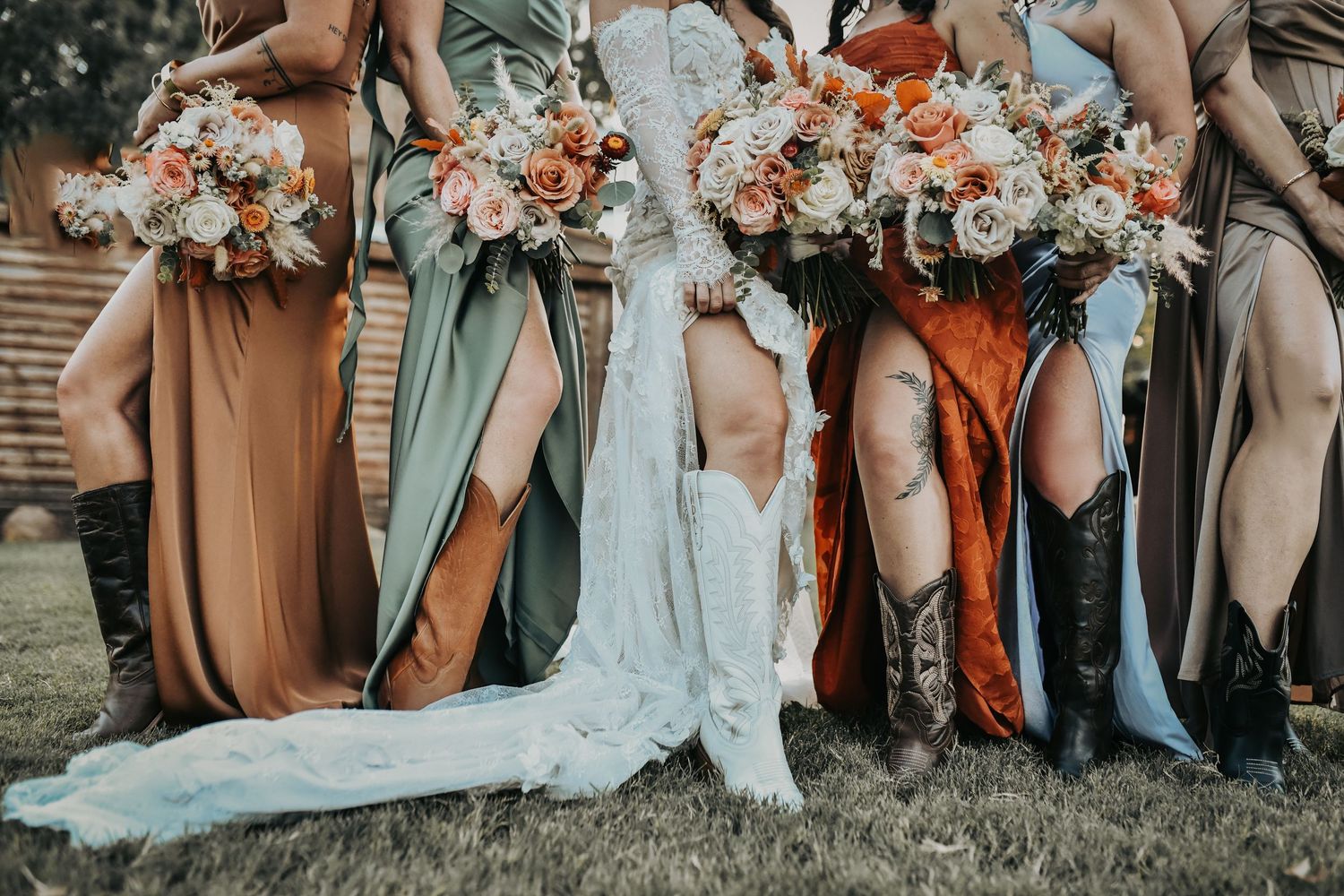 Bridesmaids wearing mismatched fall colors at a ranch wedding