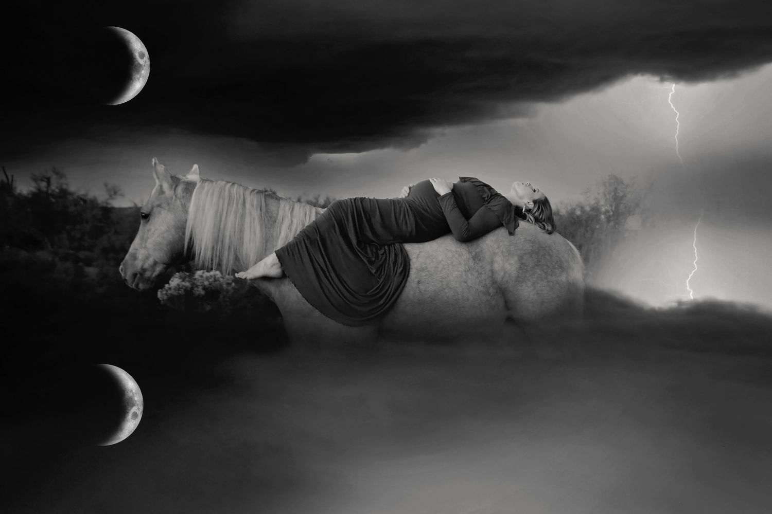Black and white fantasy scene of a woman reclining on a white horse beneath crescent moons and stormy lightning clouds.