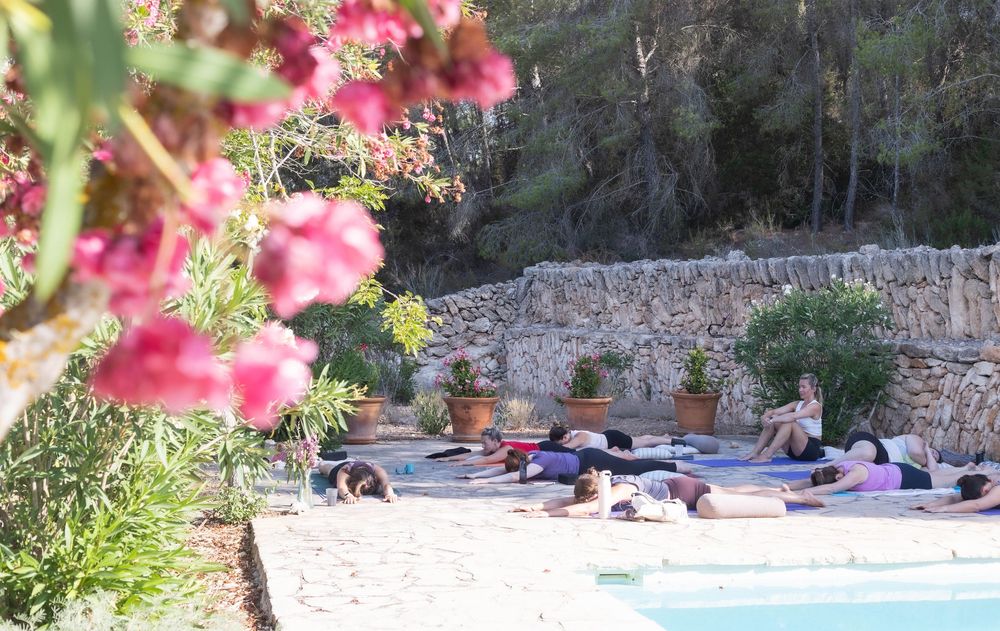 Yoga by the pool on wellness retreat in Ibiza.  Photography capturing wellness retreat.