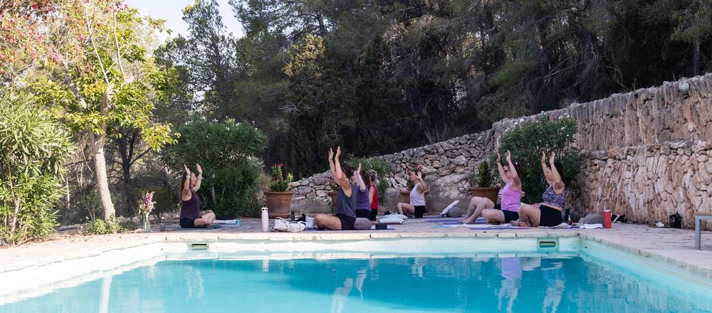 Photography of yoga session by the pool on a wellbeing retreat