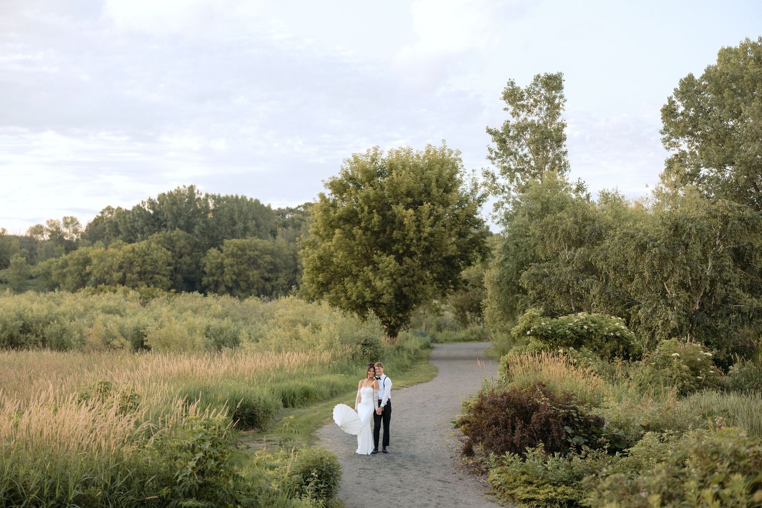 Sunset photo of bride and groom after changing into their American wedding attire for the reception at Millenium Gardens in Plymouth, MN.
