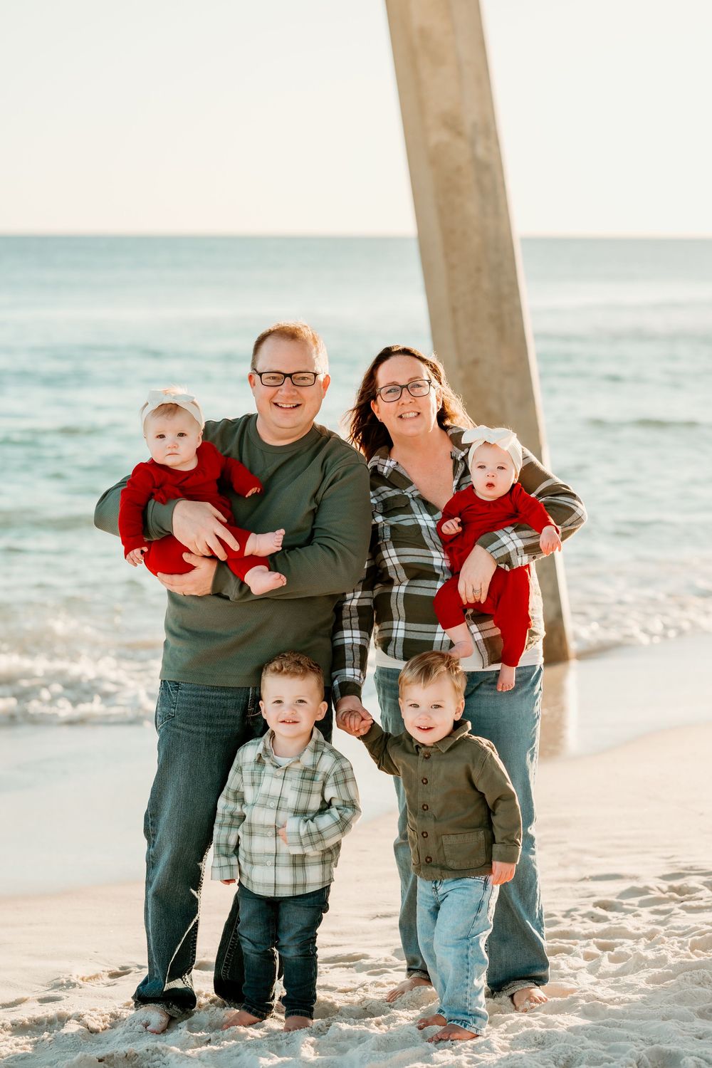 Family with four young children together during an extended family session on Pensacola Beach