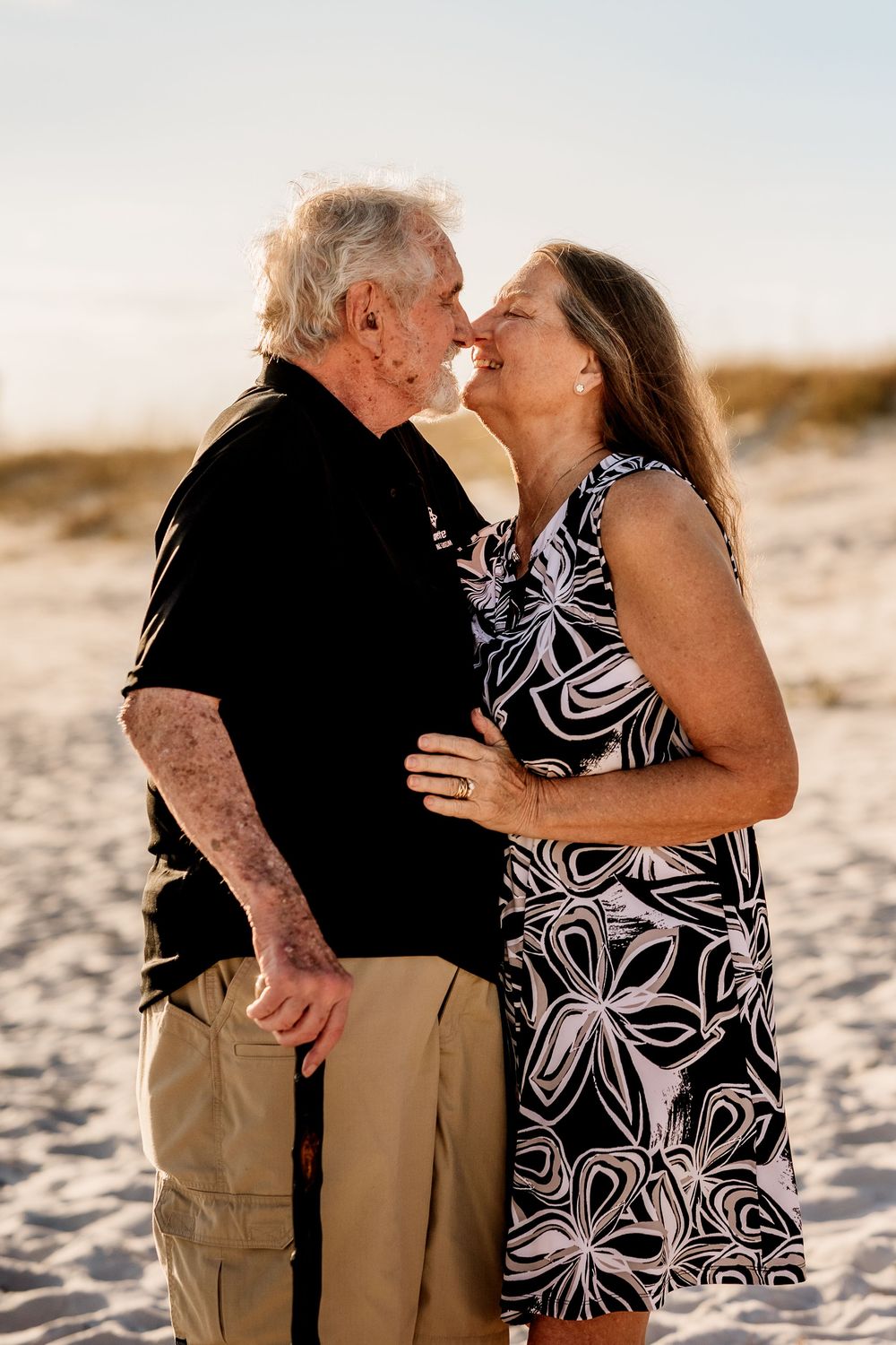 Older couple sharing a playful moment during a beach photography session