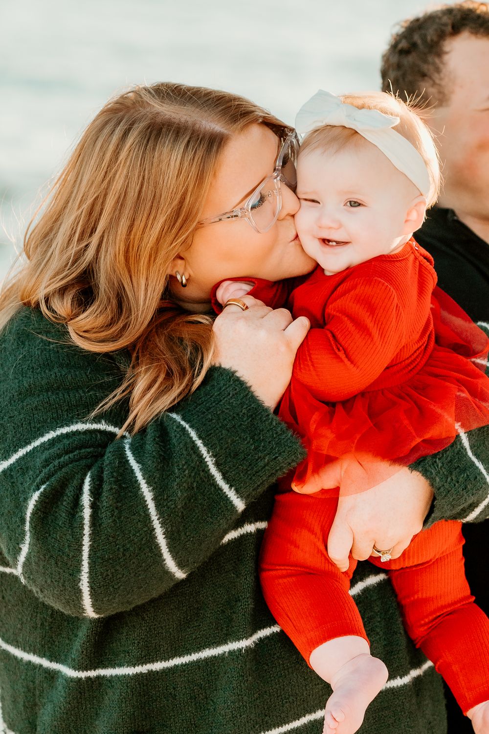 Mother kissing her baby during an extended family photography session
