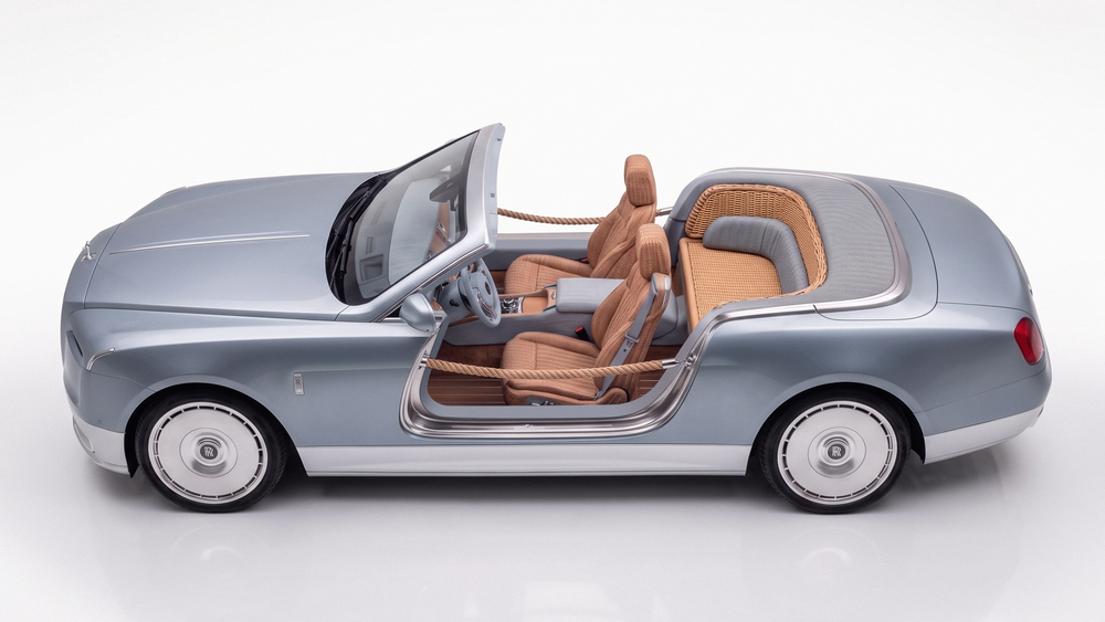 Luxury Bentley convertible concept car in silver-blue with tan leather interior, shown from above with doors open.
