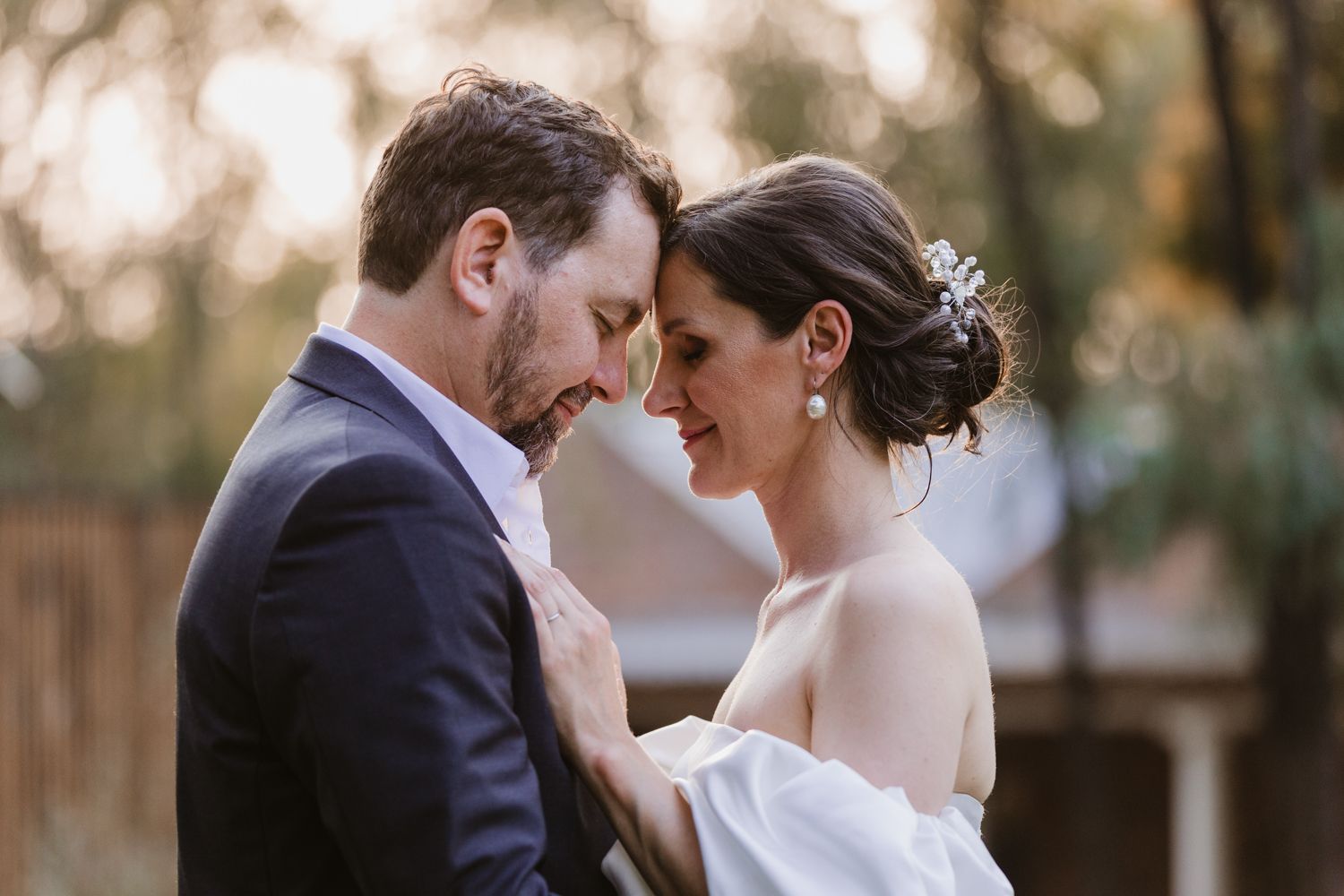 Close-up of the groom and bride taking a moment in silence during their wedding shoot.