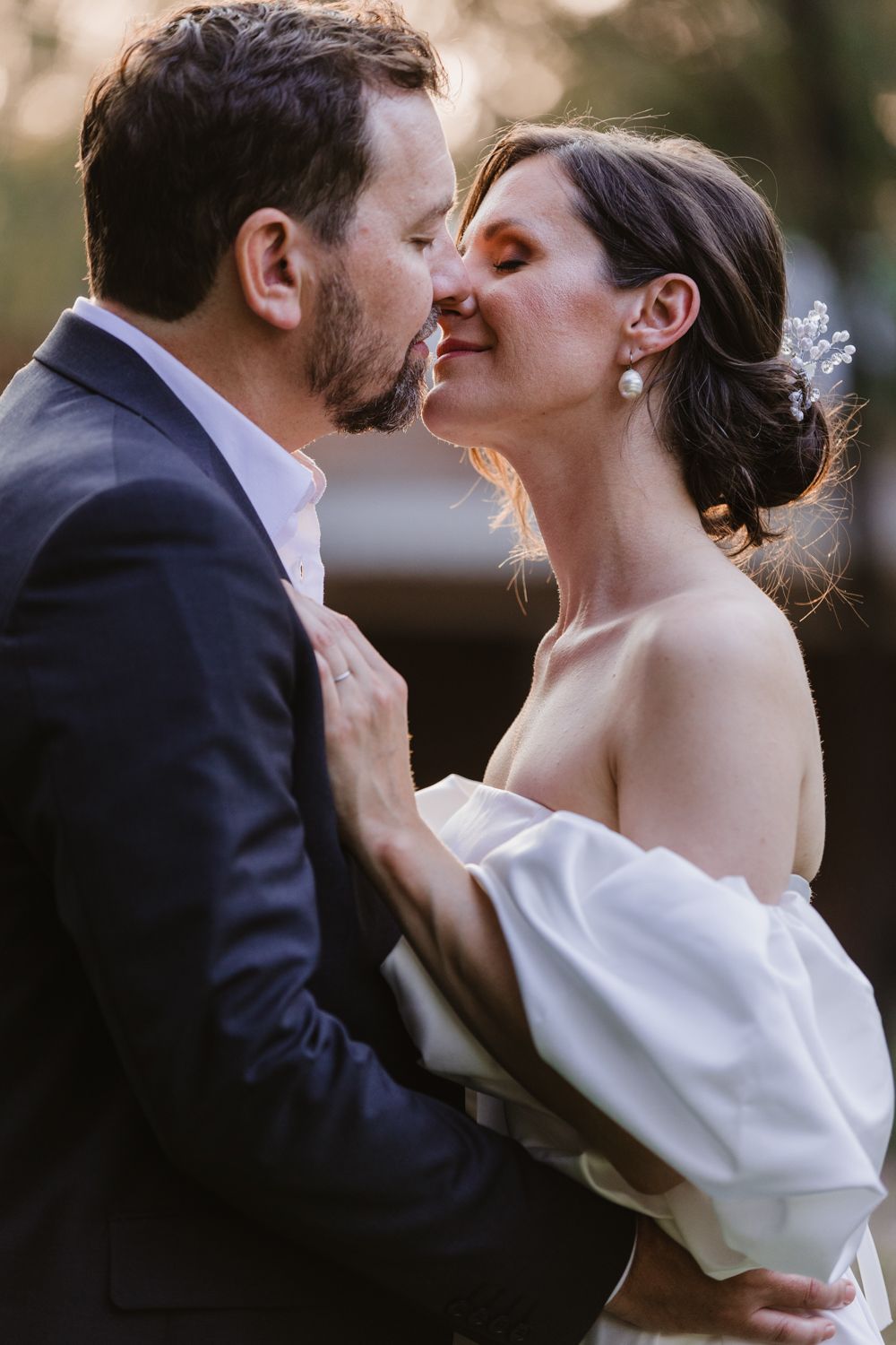 Bride and groom laughing together during a candid outdoor moment.
