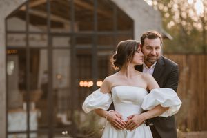 Romantic moment of the couple embracing in the doorway.