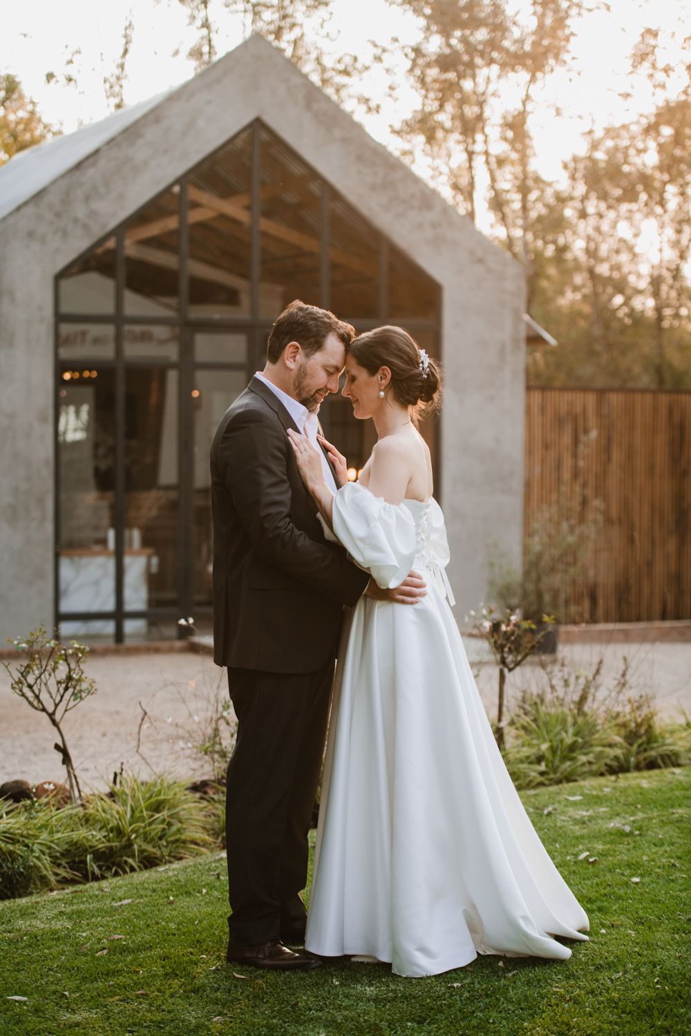Romantic sunset portrait of the couple embracing outdoors.