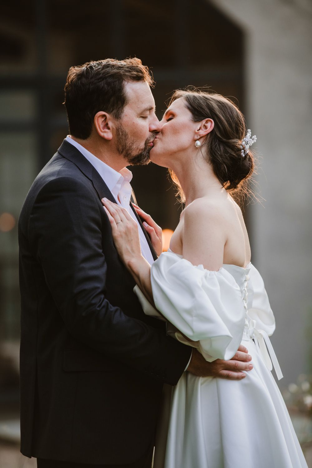 Intimate portrate of the couple kissing outside their venue for their wedding day photoshoot in Gauteng.
