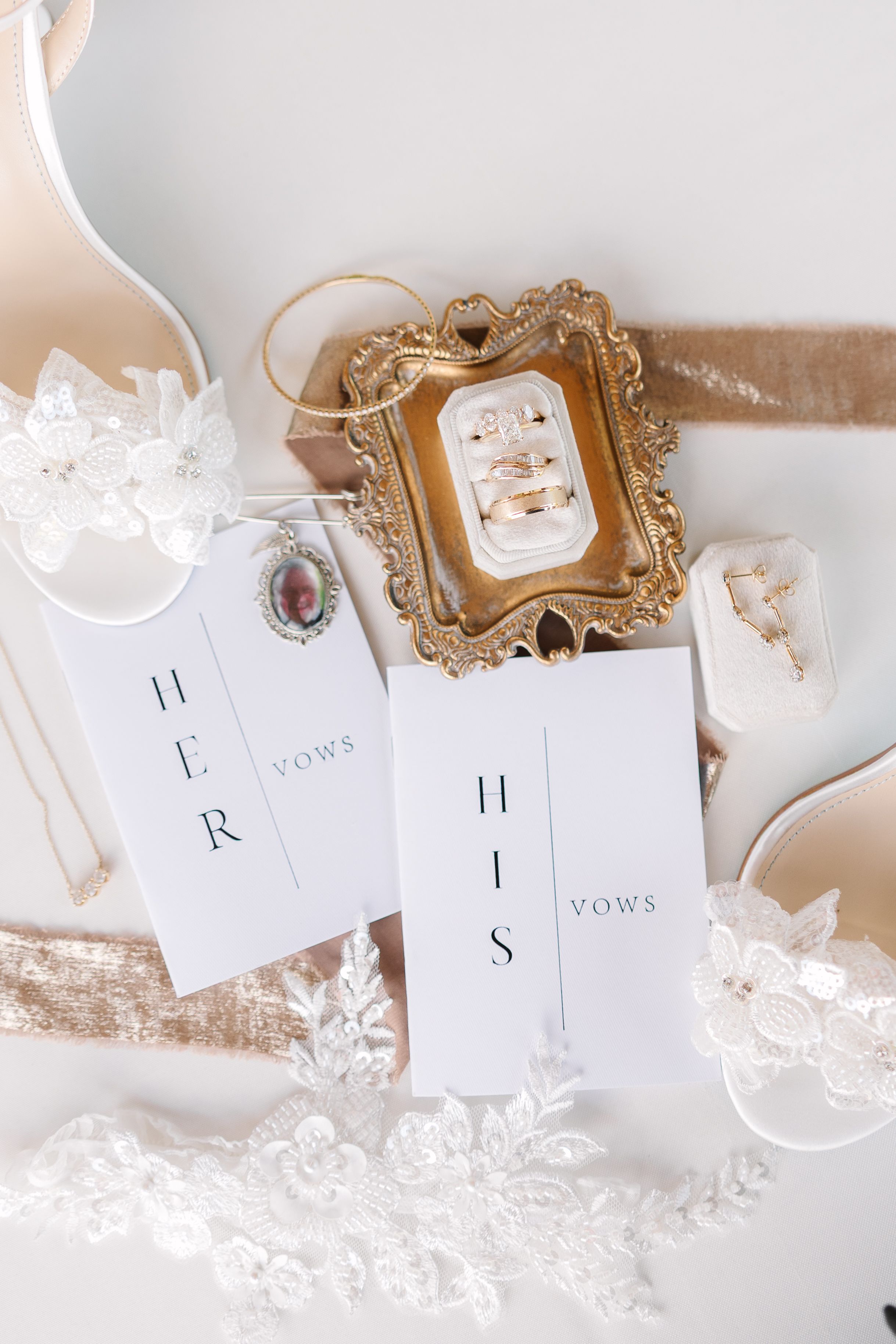 Elegant wedding vows cards displayed with an ornate gold frame and delicate lace details on a light neutral background.