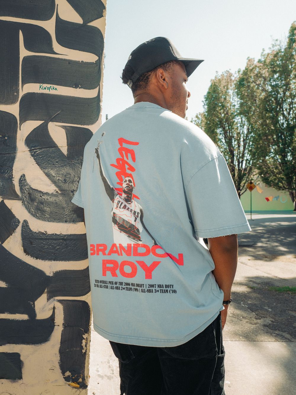 Four connected photos show a t-shirt design with 'BRANDON ROY' text visible from different angles in an outdoor setting.