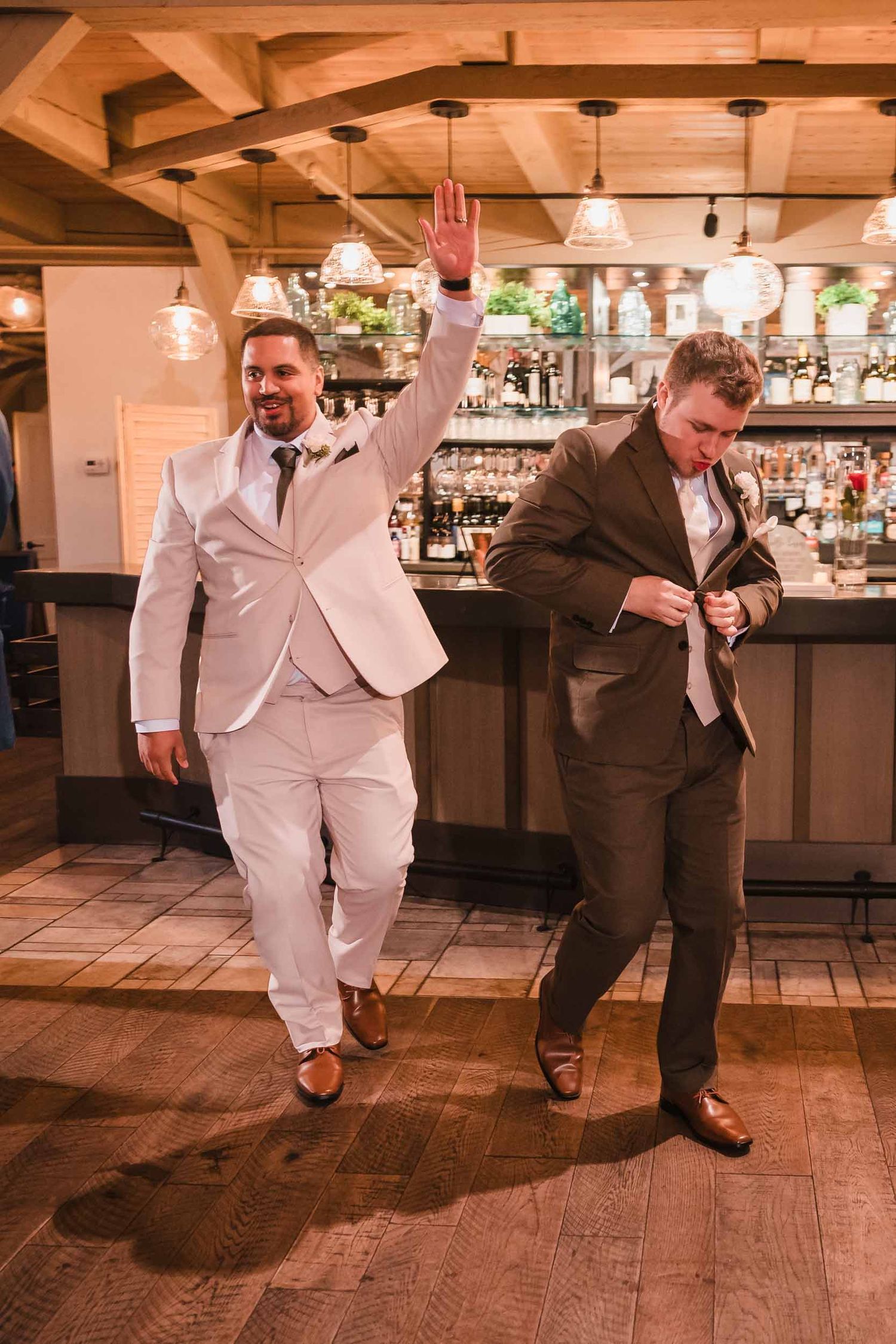 Grooms dancing into their wedding reception during grand entrance at Briar Barn Inn