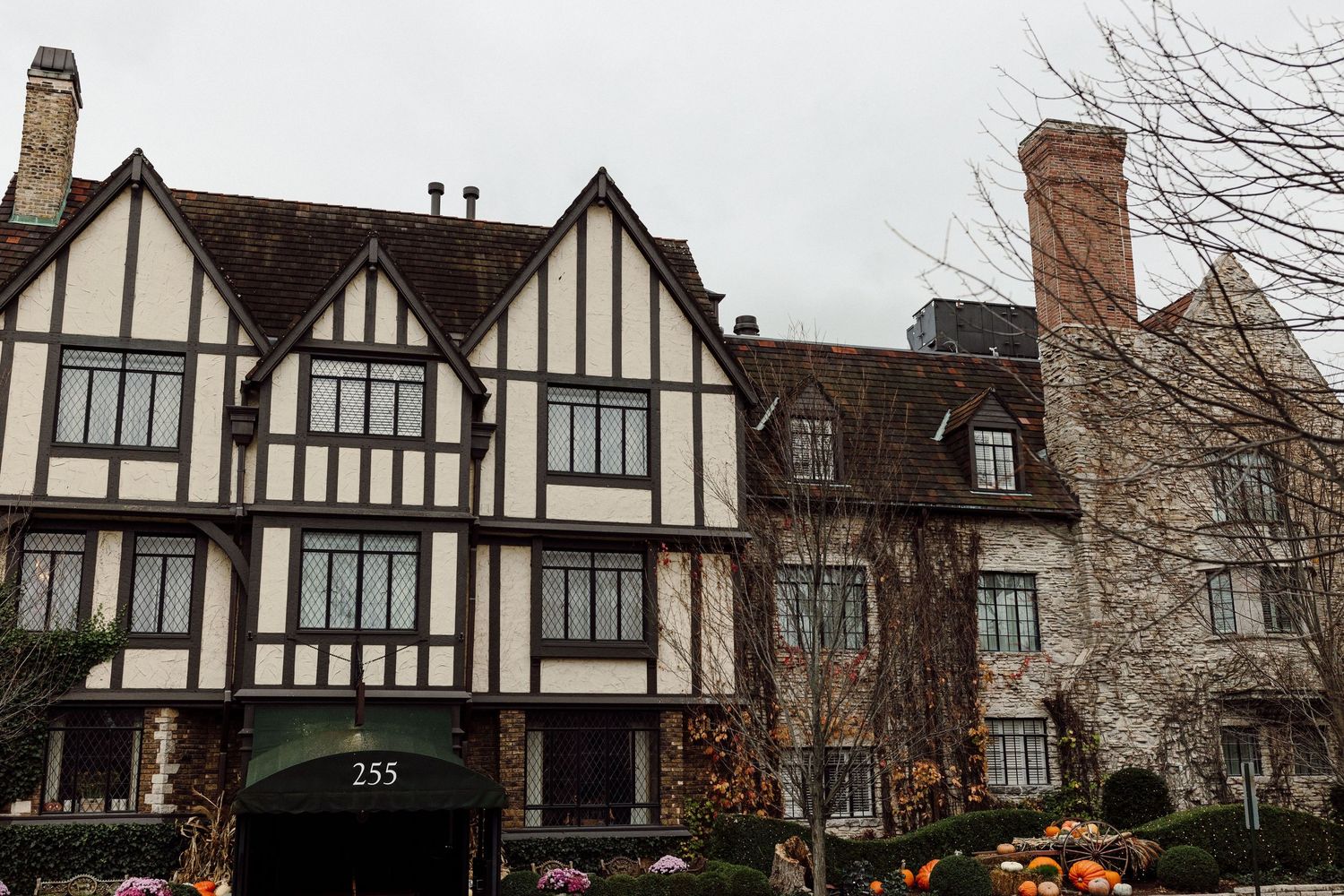 Tudor-style wedding venue exterior at 255, featuring classic half-timbered architecture surrounded by autumn decorations.