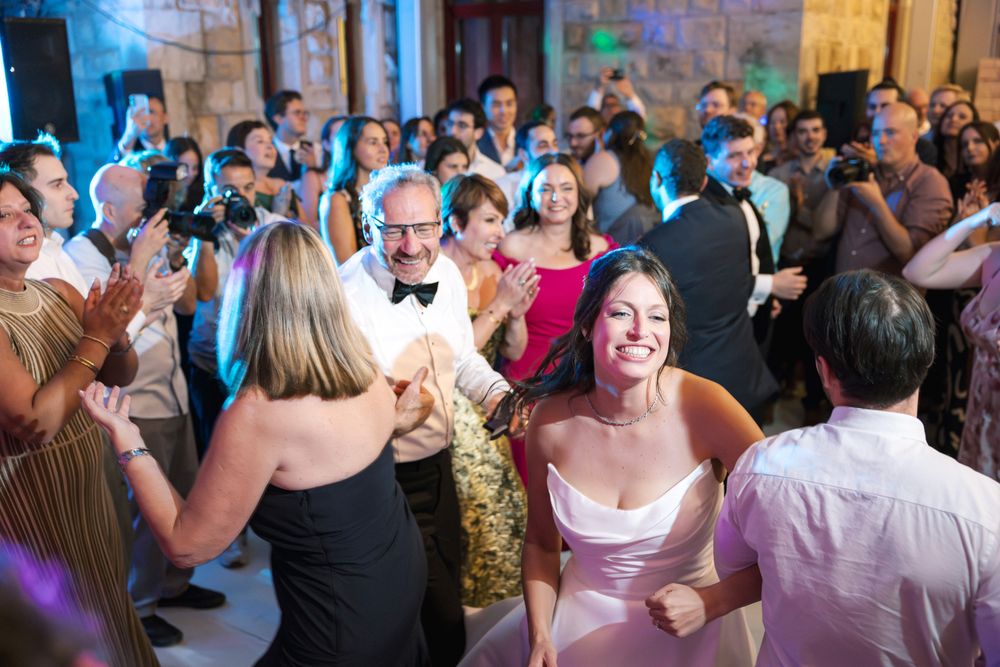 Joyful wedding party with friends dancing and celebrating together