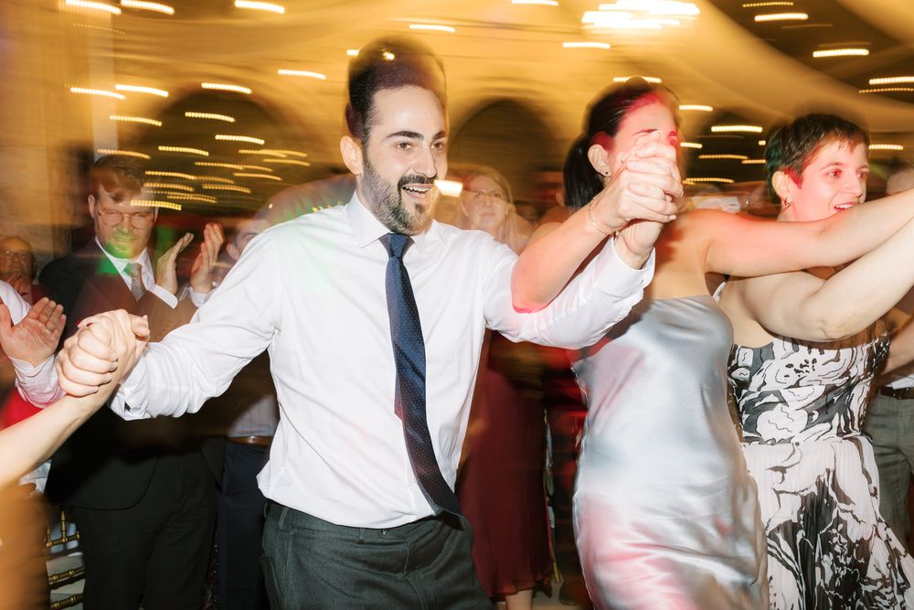 Joyful dance floor moments with guests celebrating at seaside wedding in Cascais
