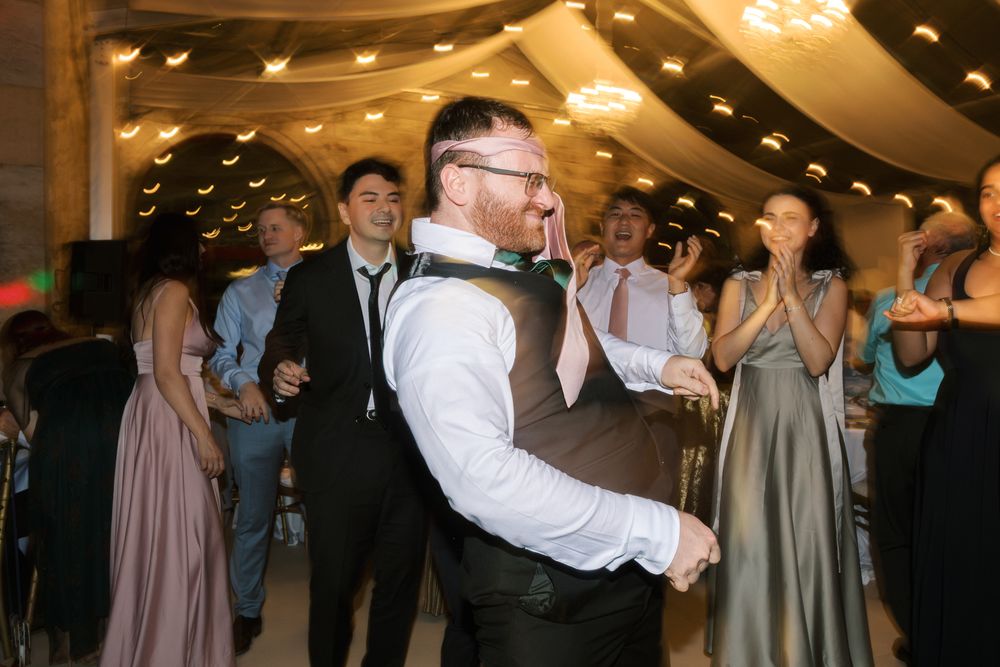 Fun and vibrant wedding dance floor captured at Forte da Cruz in Cascais