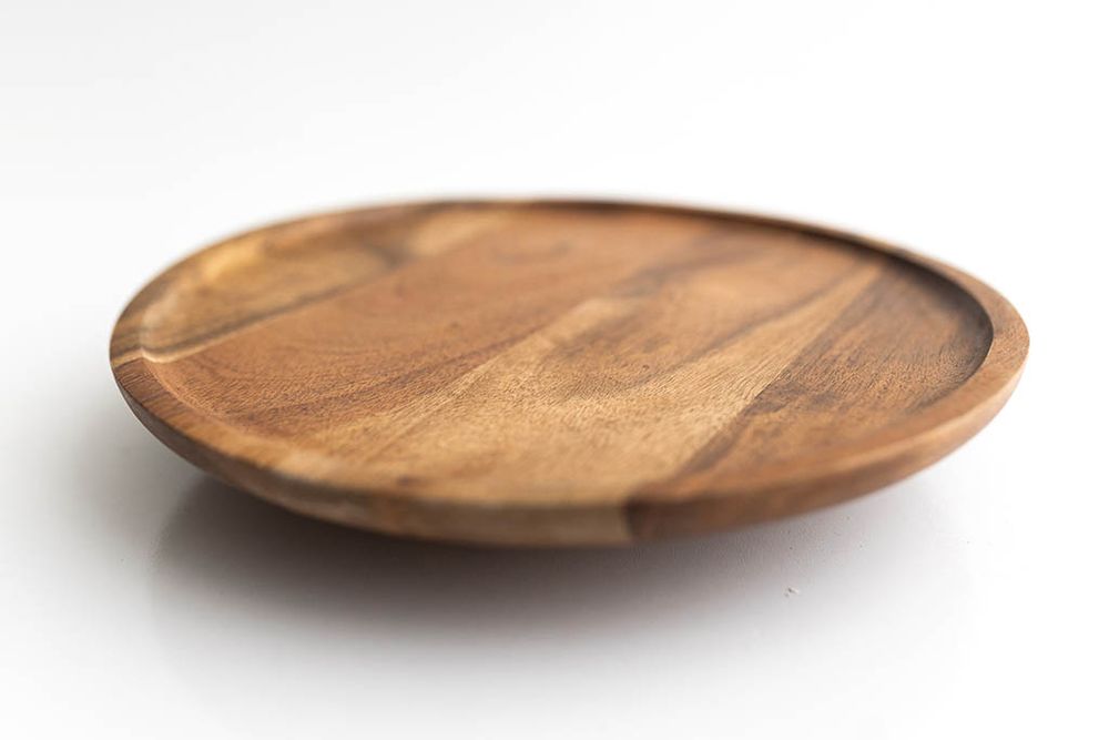 Round acacia wood serving plate for first birthday photos in Winchester California.
