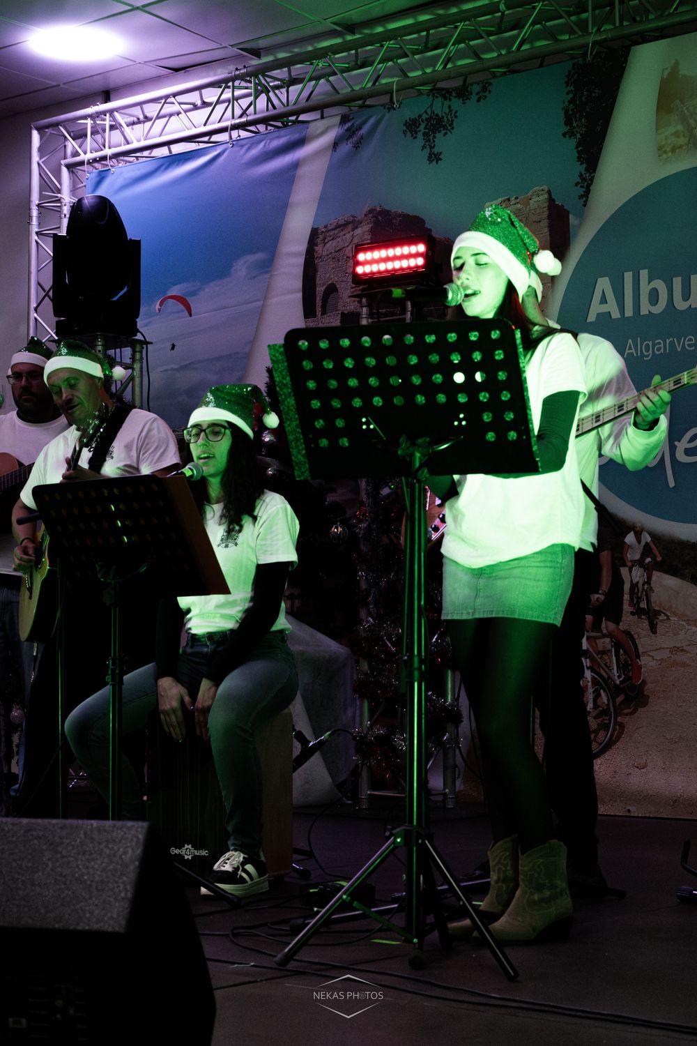 Musicians in Santa hats perform on stage at a Christmas event in Albufeira, Algarve, Portugal.