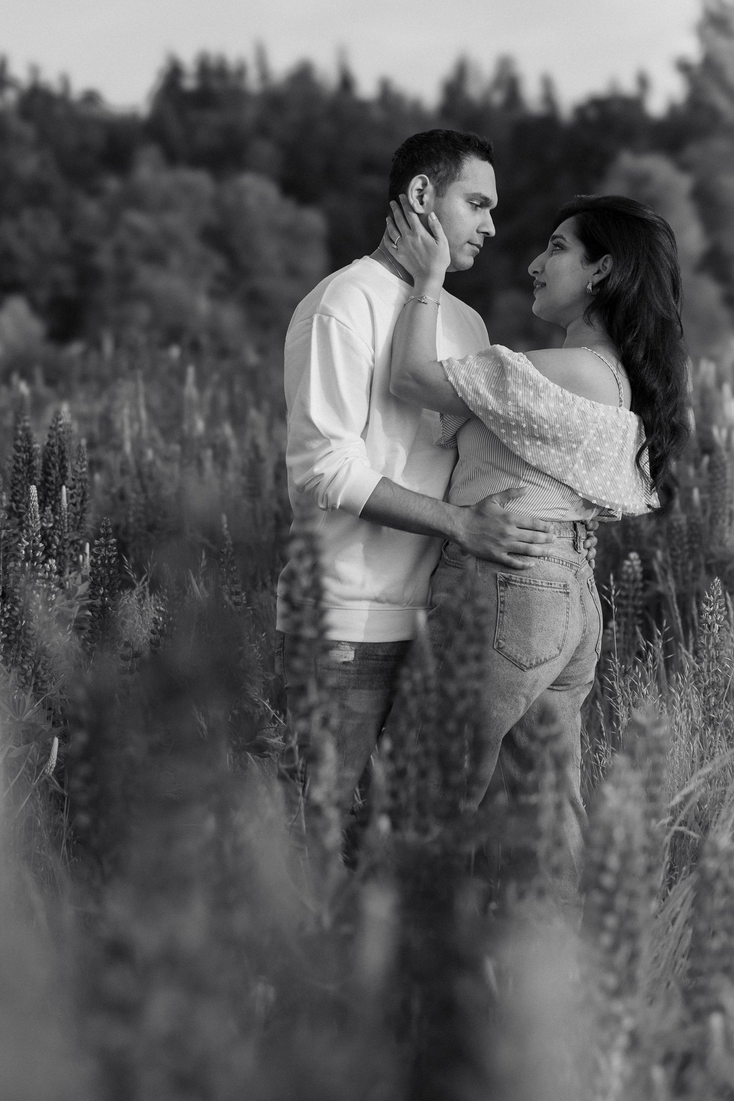 A couple embrace in a field of flowers for engagement photos near Seattle