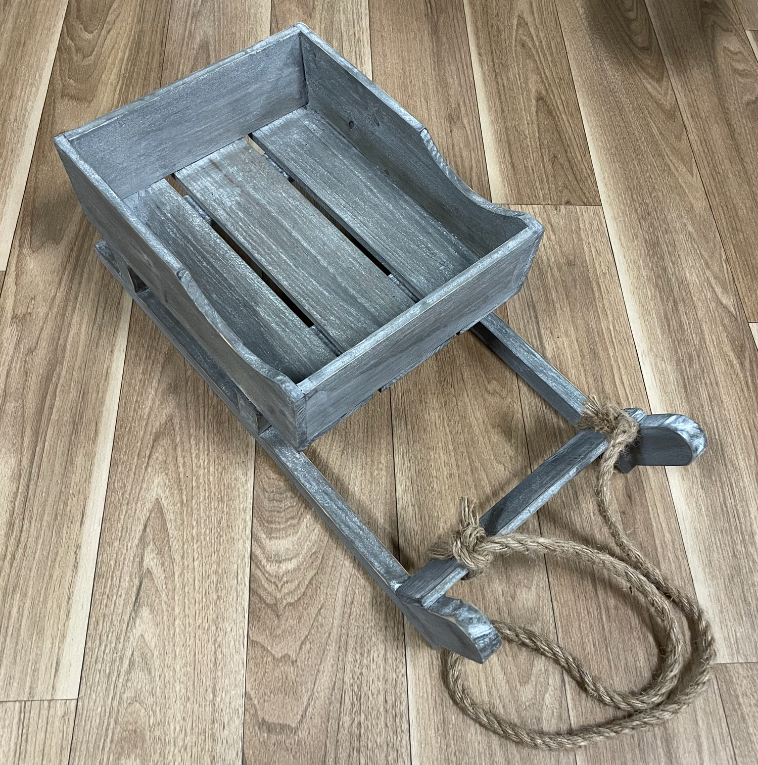 Rustic gray wooden bench or seat shown in various assembly stages.