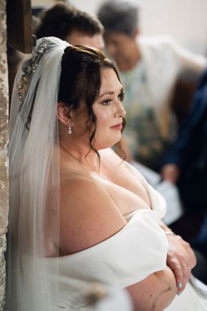 Three photos showing a bride in an elegant white off-shoulder wedding dress with a flowing veil and dark hair.