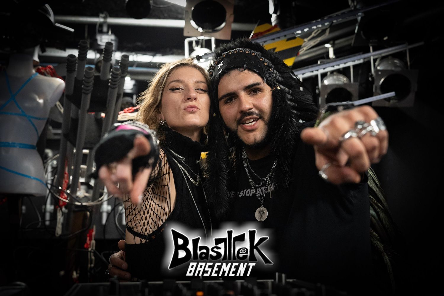 Couple of DJs posing at a party with intense lighting, showcasing authentic event photography. tekno, dark psy, psy Rave. Blastek. Vivitu