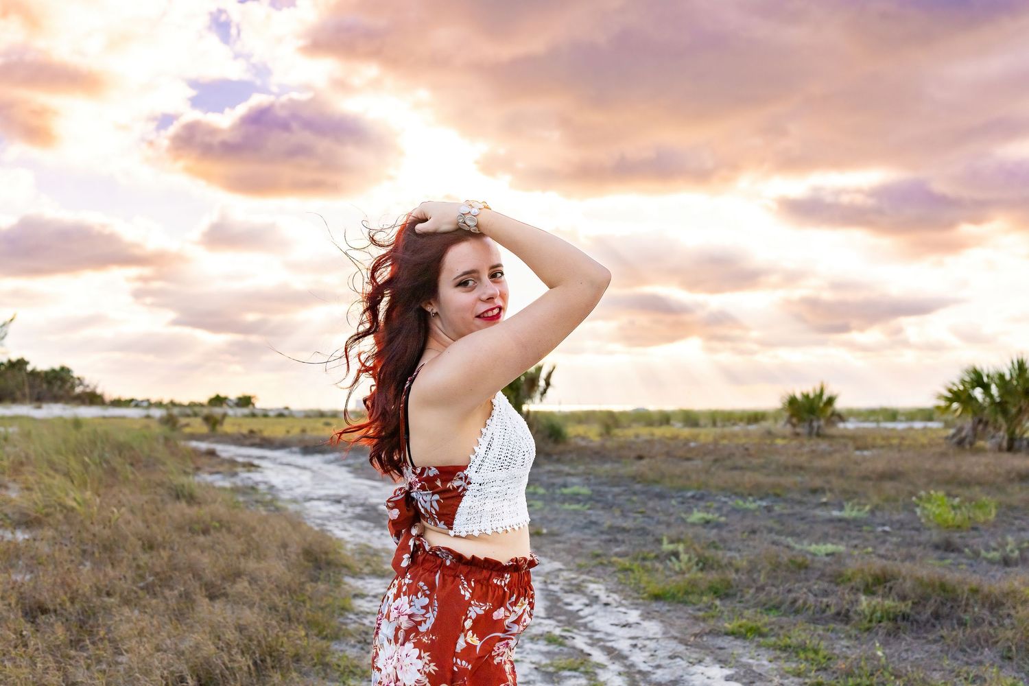 Dreamy sunset photoshoot on beach with flowing red dress.