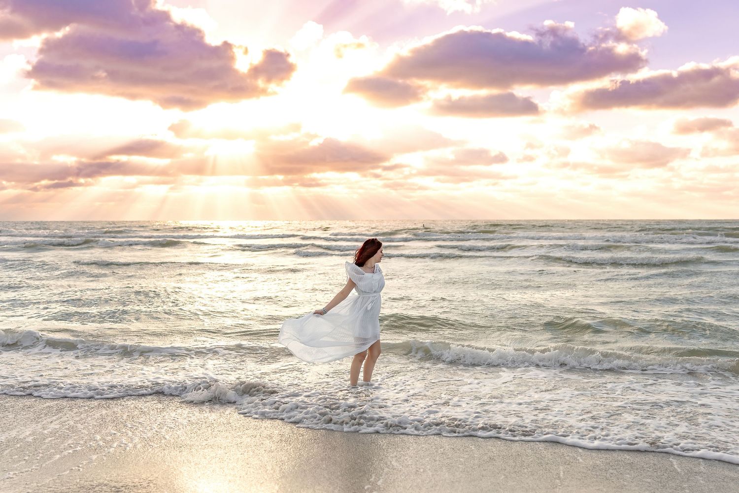 Ethereal beach portraits with waves and sunset clouds in background.