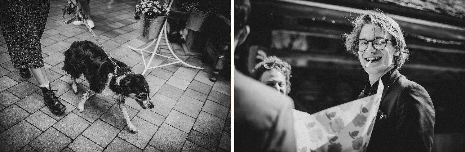 Black and white photo of dog and celebration at outdoor event venue.