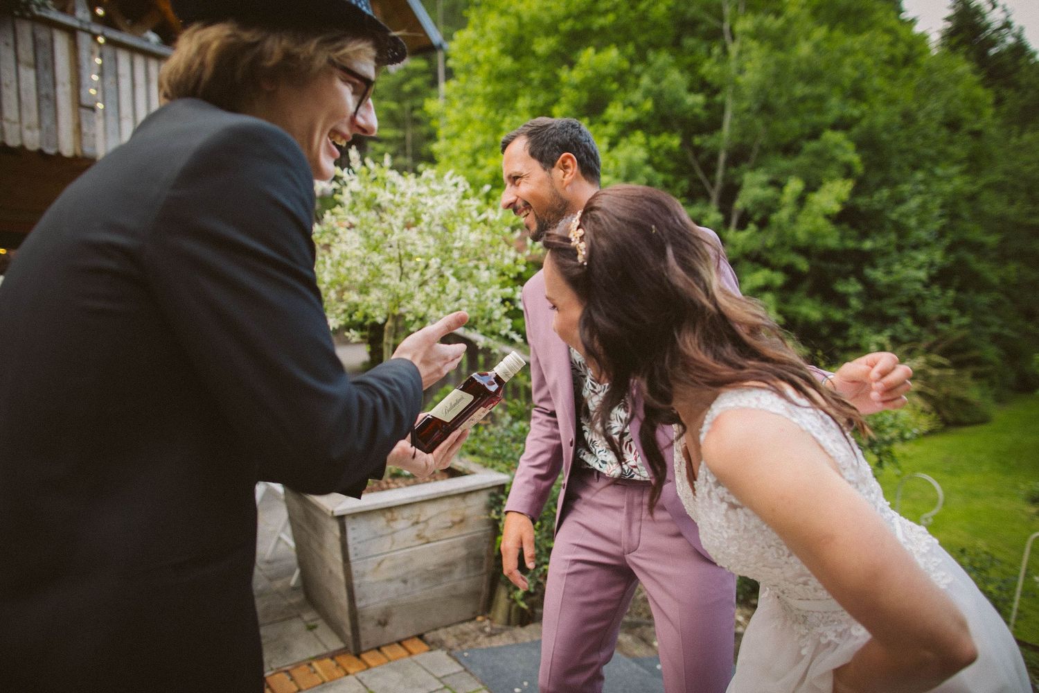 Lively celebration moment outdoors with guests in spring garden setting.