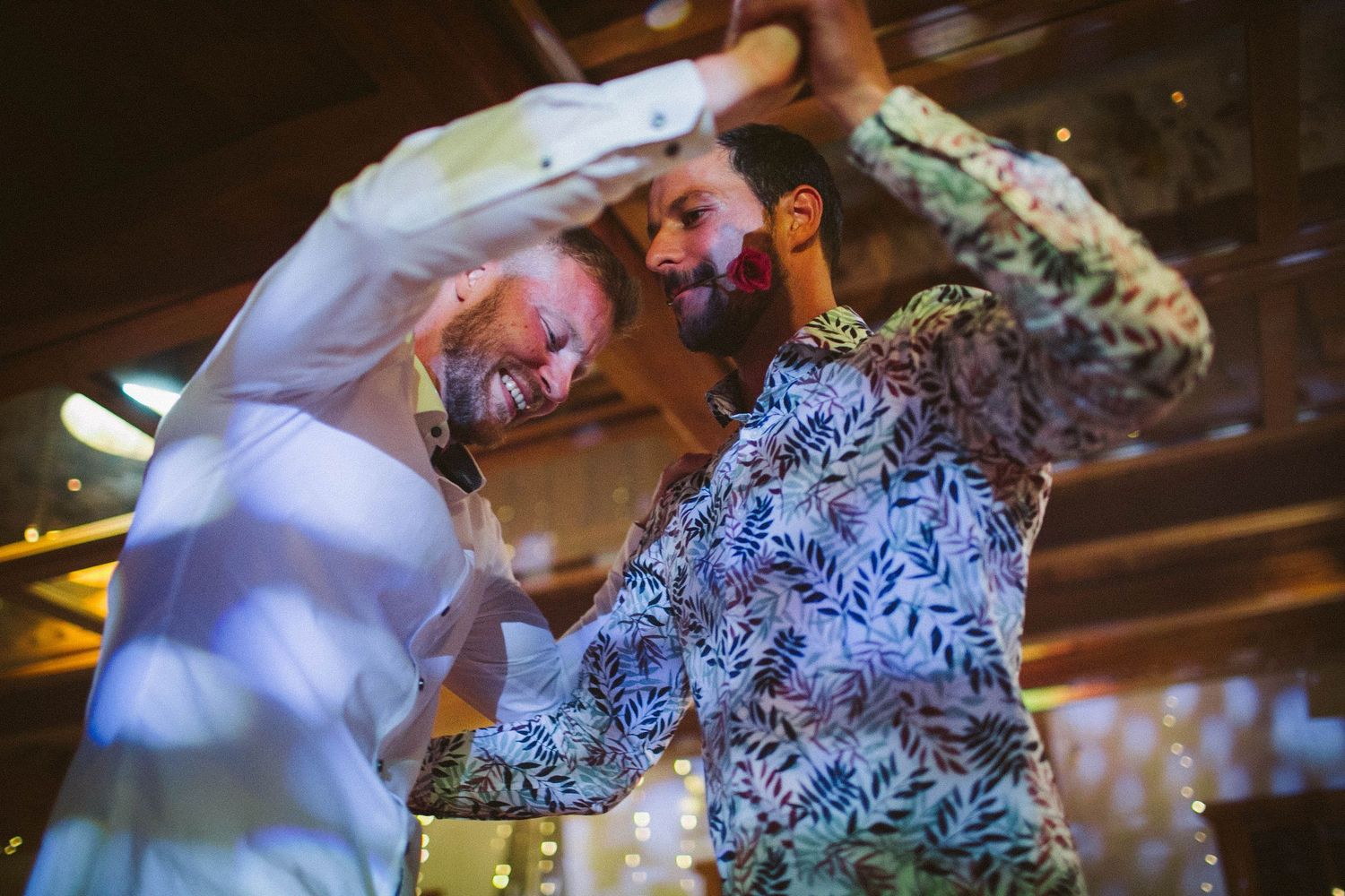 Dynamic dance moves captured during lively wedding reception celebration.